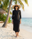 Model wearing style 2636 zippered skirted capri with style 2637 zippered swim top in black at beach
