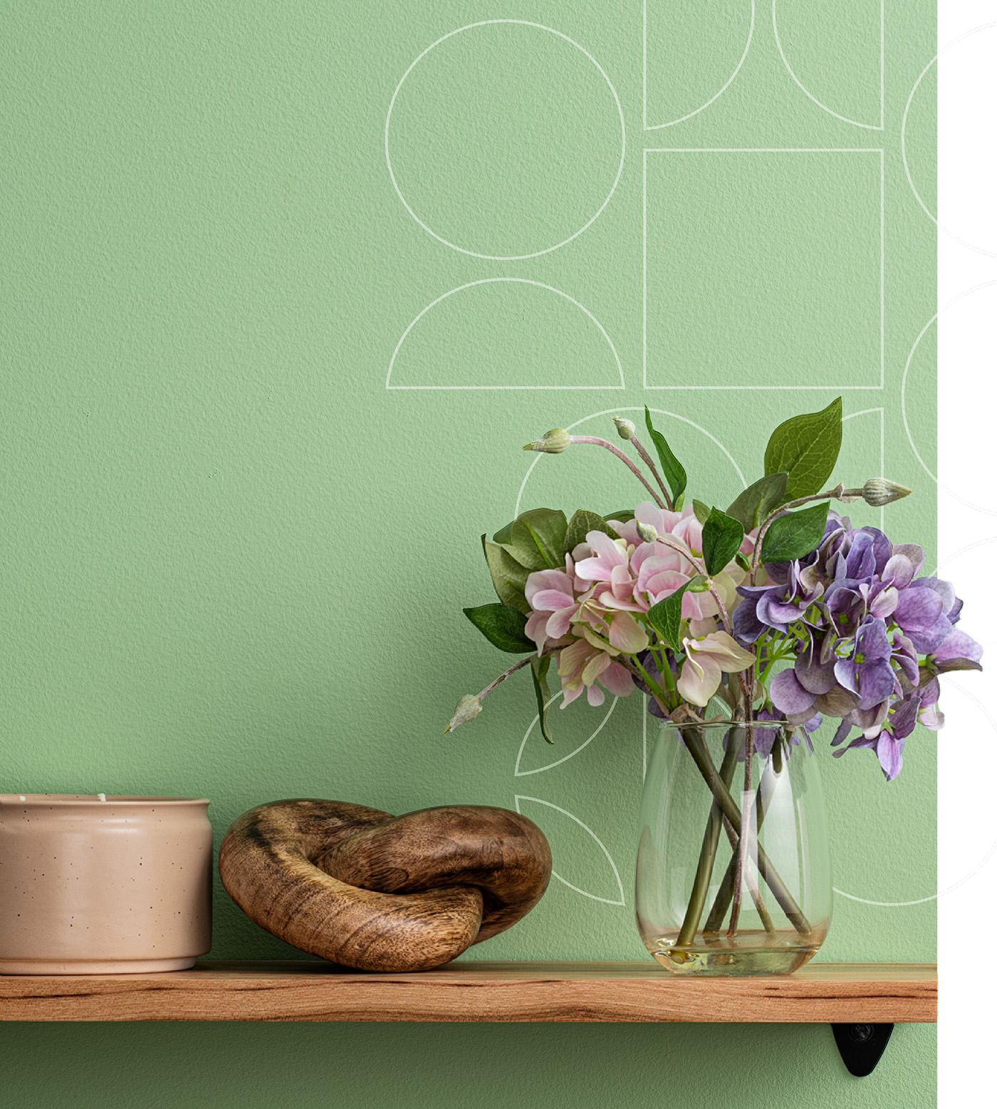 image of flowers and candle on shelf with light green background
