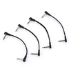 Four compact black guitar effects pedal patch leads arranged on white background