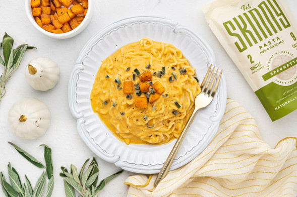 A bowl of creamy butternut squash spaghetti. Low carb spaghetti noodles cooked in a creamy butternut squash sauce, topped with roasted squash and fresh sage.