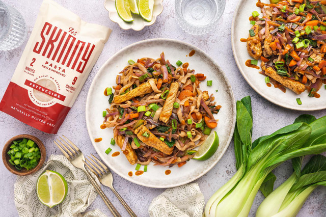 An overhead image of two bowls of low carb pork stir fry made with It's Skinny fettuccine noodles.