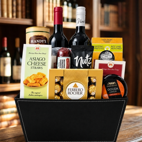 Black wine gift basket with two wine bottles, Ferrero Rocher chocolates, smoked Gouda, summer sausage and gourmet snacks.