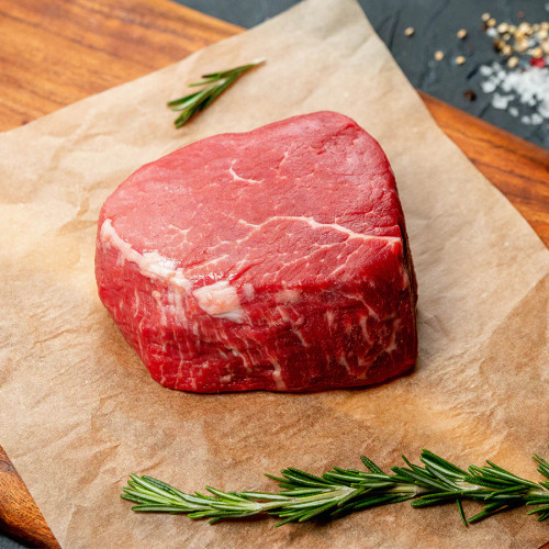 Raw Filet Mignone Boneless Steak over brown parchment paper