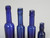 Collection of '15' Cobalt Blue Caster Oil Hand Blown Bottles Made in 1800s, United Kingdom 4 heights top view down