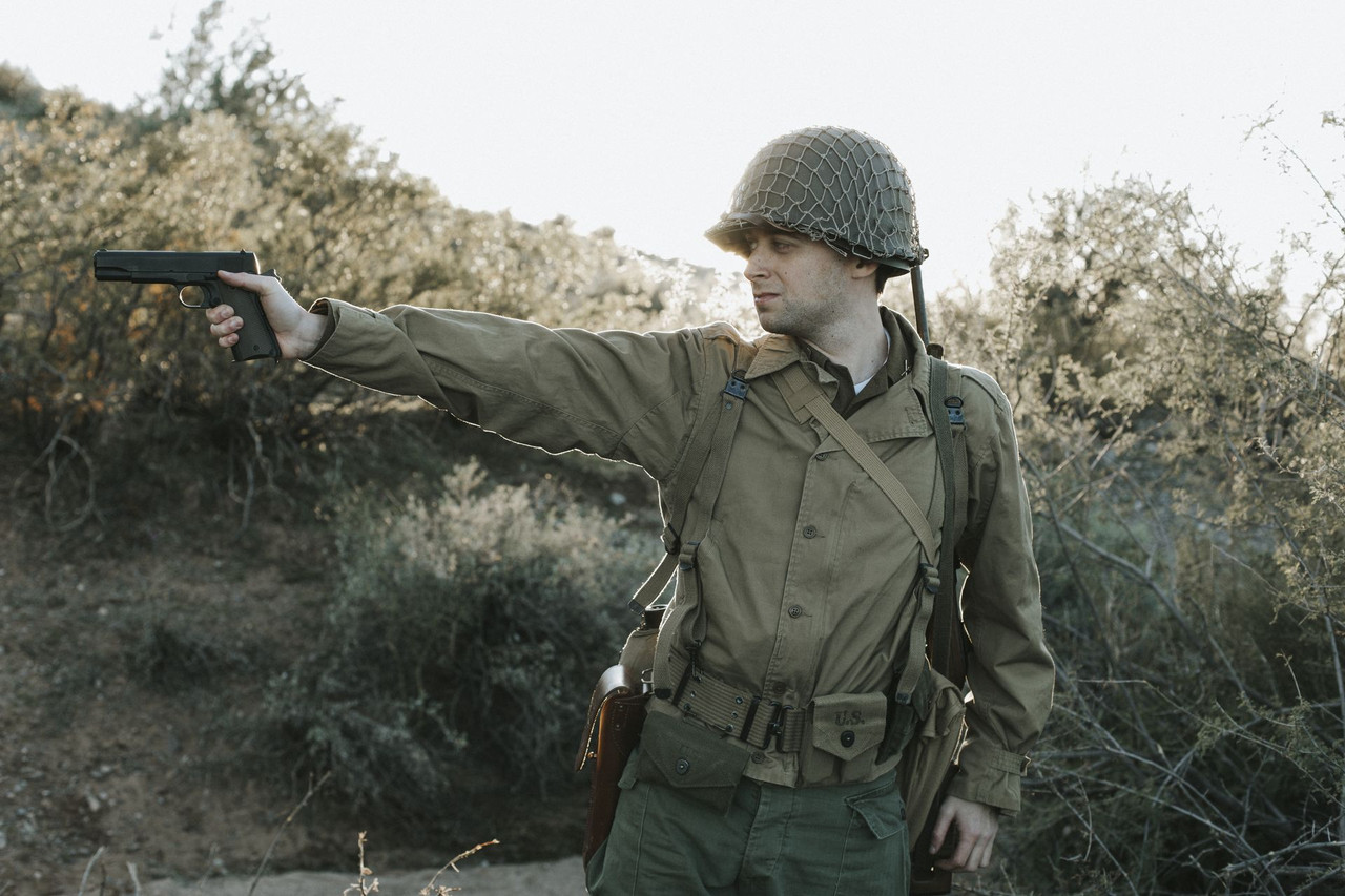 Lifestyle | 1911A1 US Army | a soldier in WWII kit with the pistol held out at arm's length