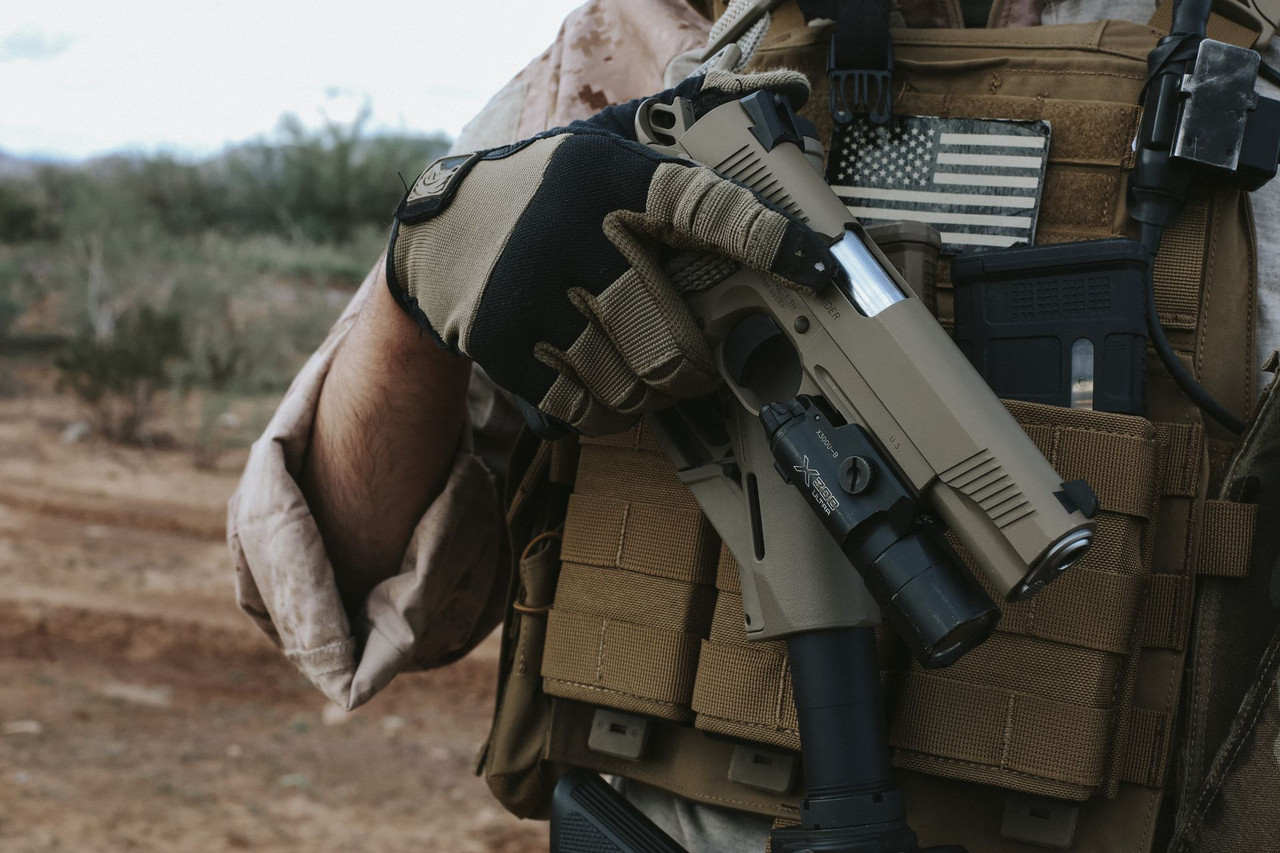 Lifestyle | 1911 Duty Raider | FDE with a light, drawn from the plate carrier