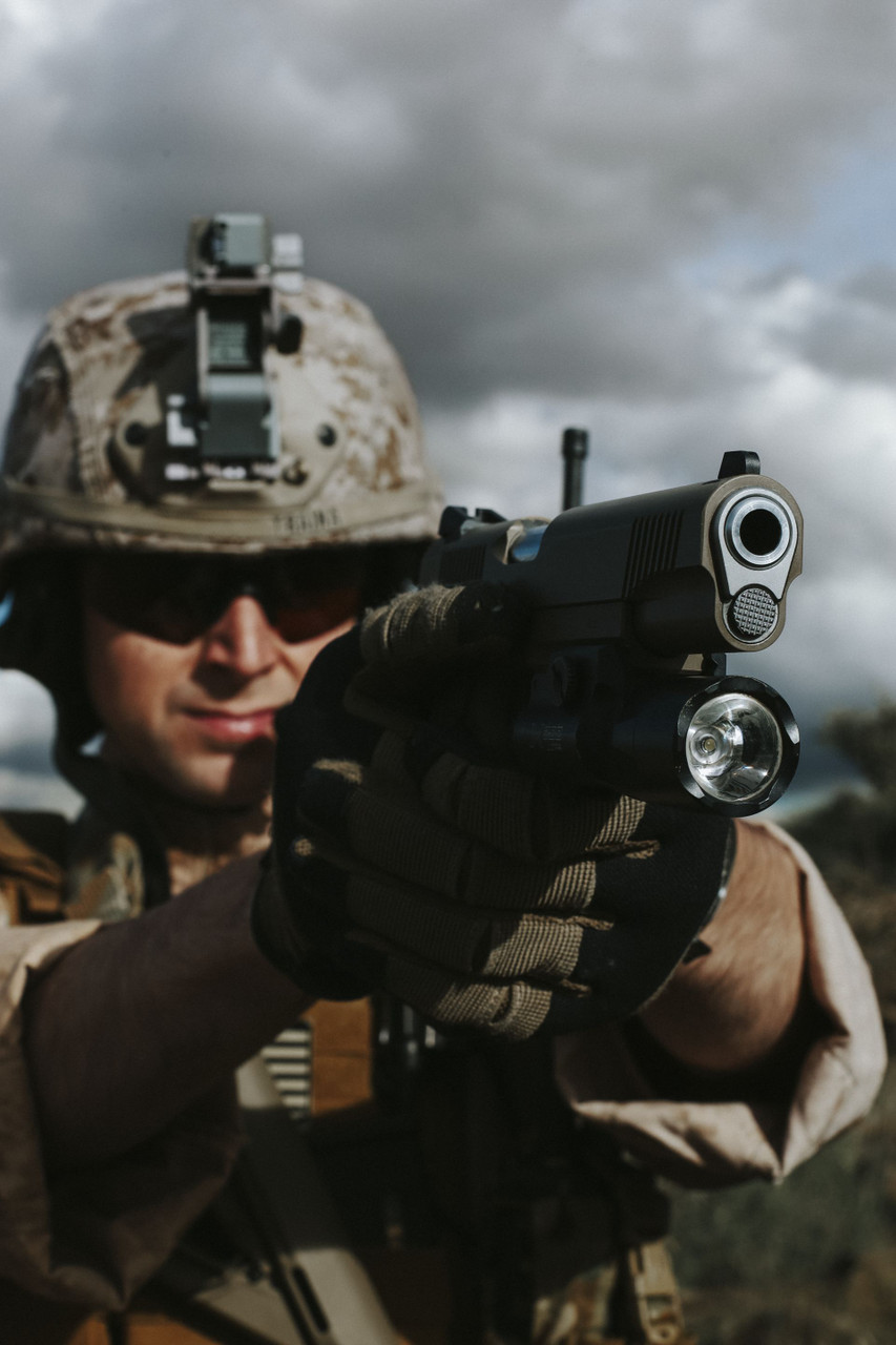 Lifestyle | 1911 Duty Raider | FDE with a weapon light, aimed at the camera