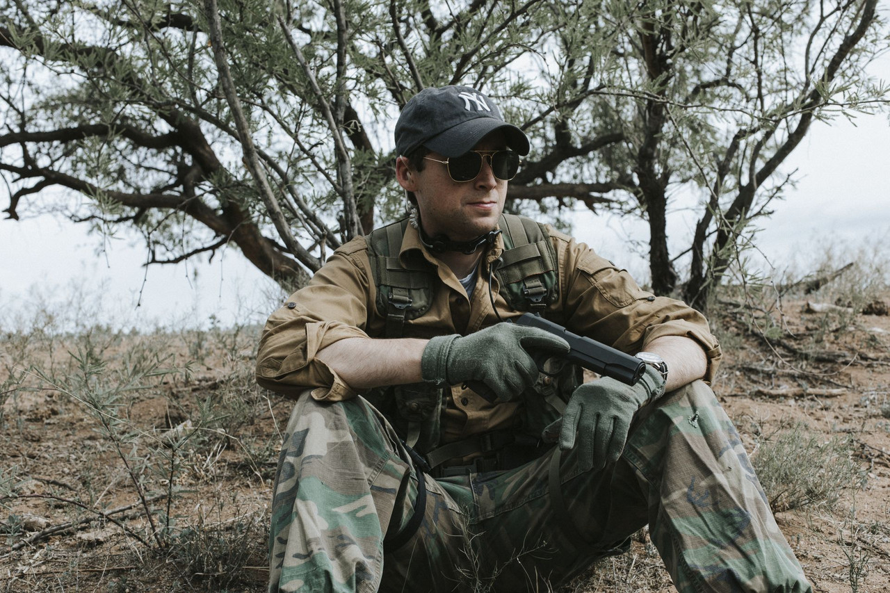 Lifestyle | 1911A1 Service | seated under a mesquite tree, pistol across the knee