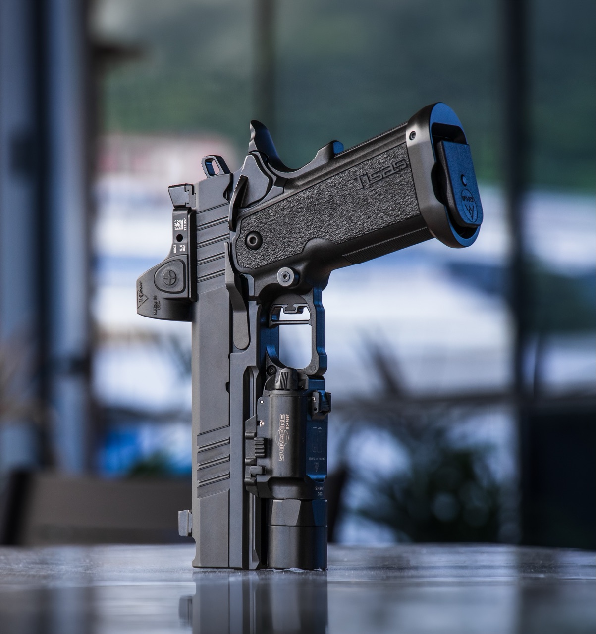 Tisas double stack with a red dot and a weapon light, set up for duty