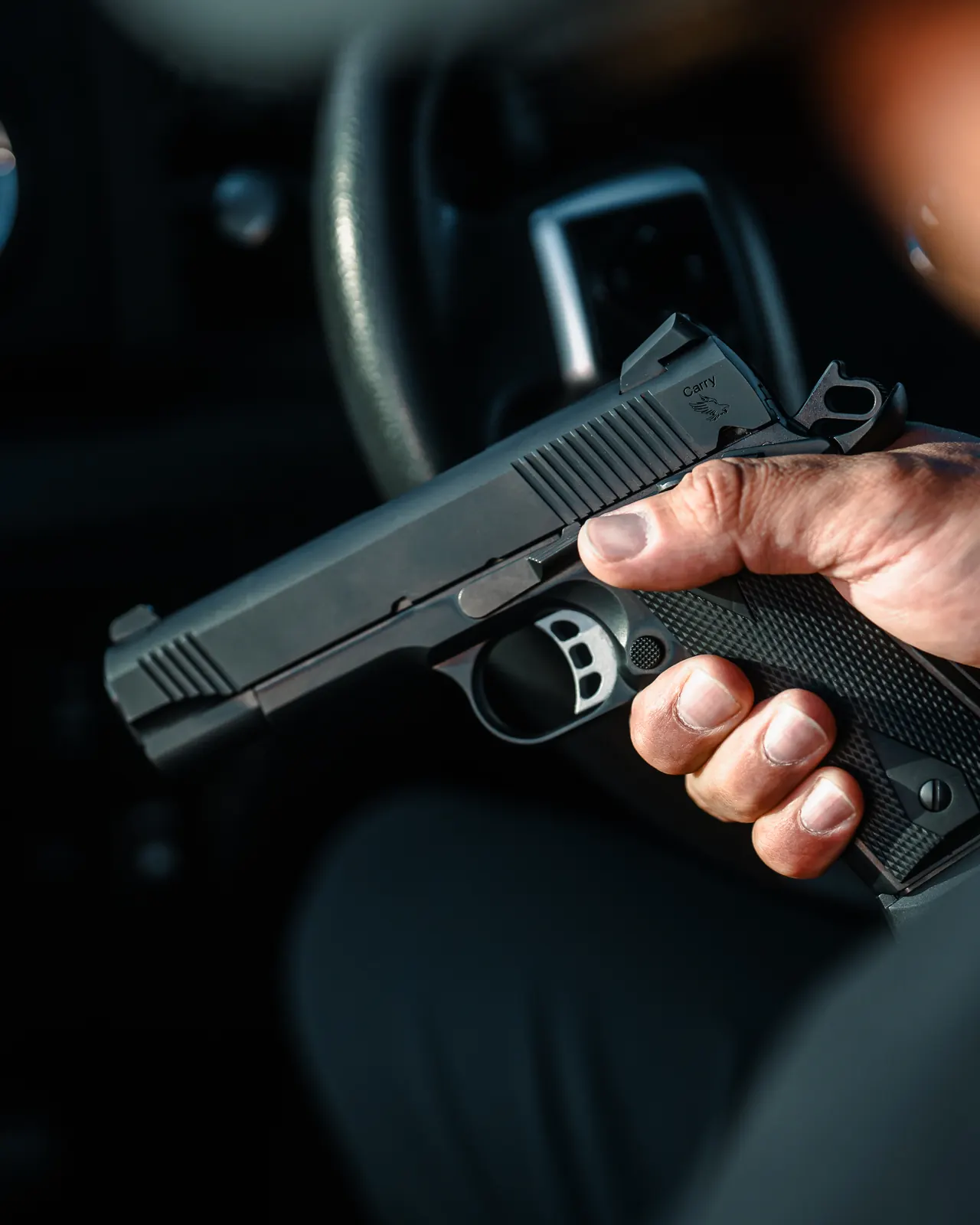 A Tisas 1911 Carry held inside a vehicle