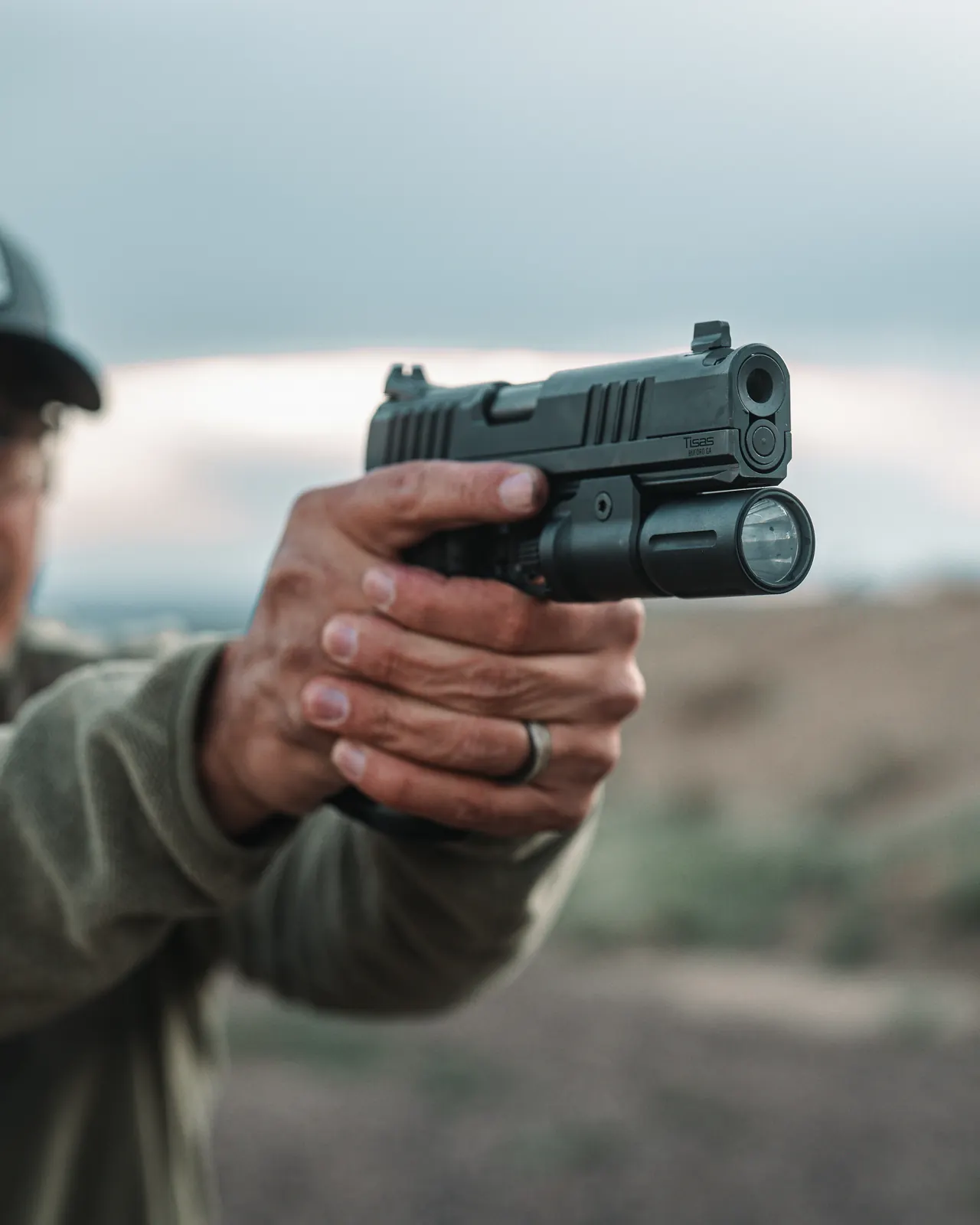 A Tisas Double Stack 9mm with a weapon light presented on the range