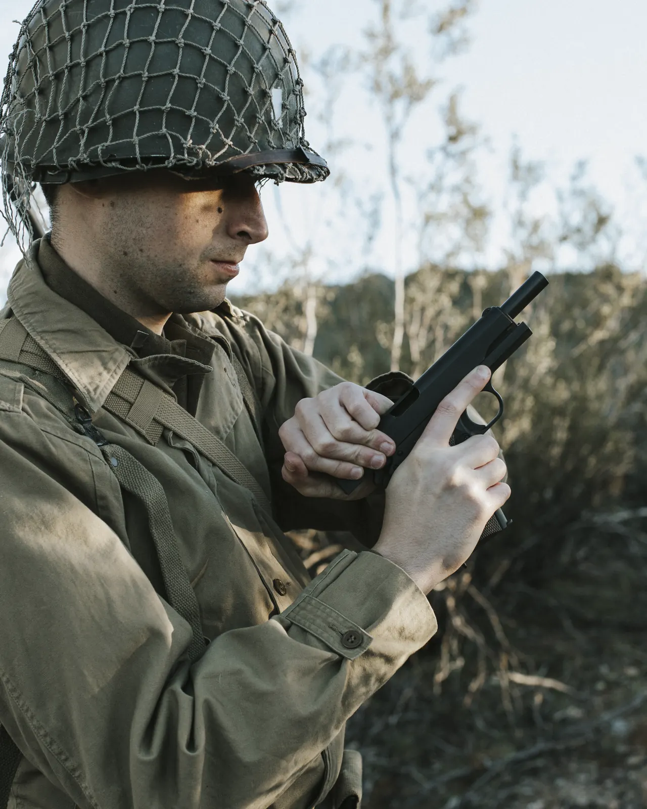 A GI pattern Tisas 1911A1 held by a soldier in WWII uniform