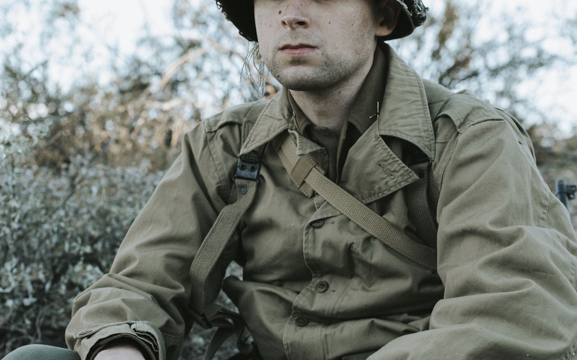 WWII pattern soldier seated with a 1911 resting on his knee