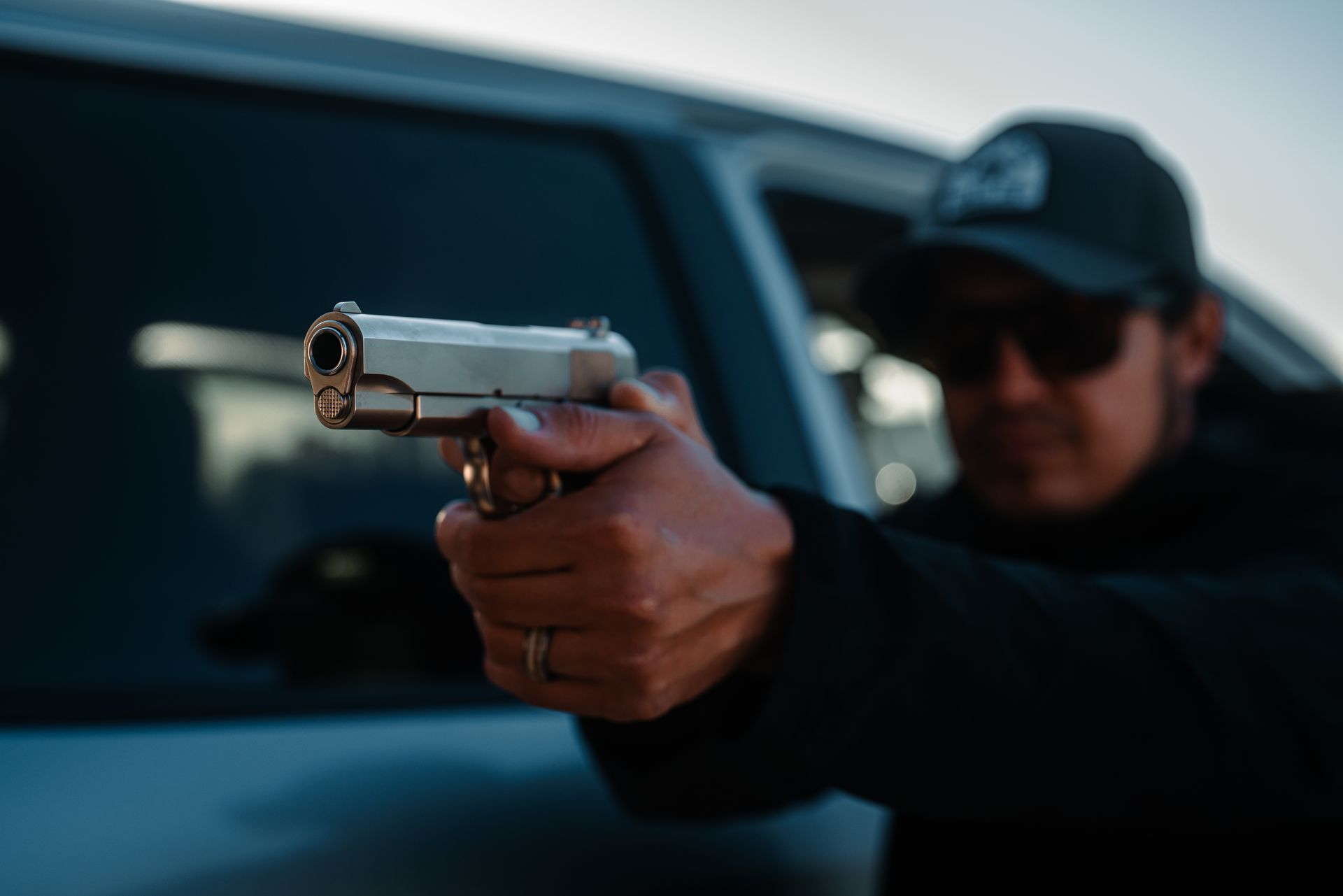 A stainless Tisas 1911A1 fired from behind a vehicle door