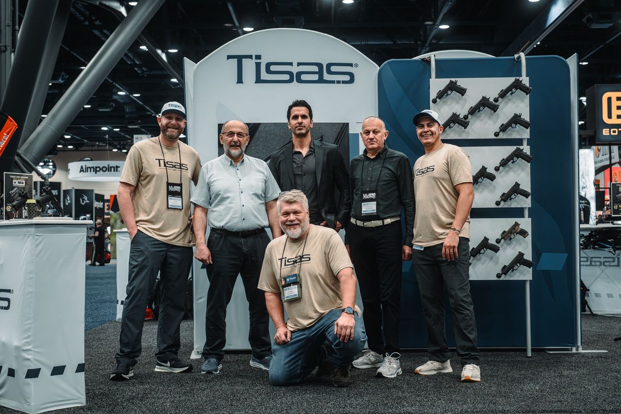 The Tisas USA team in front of the Tisas booth at a trade show