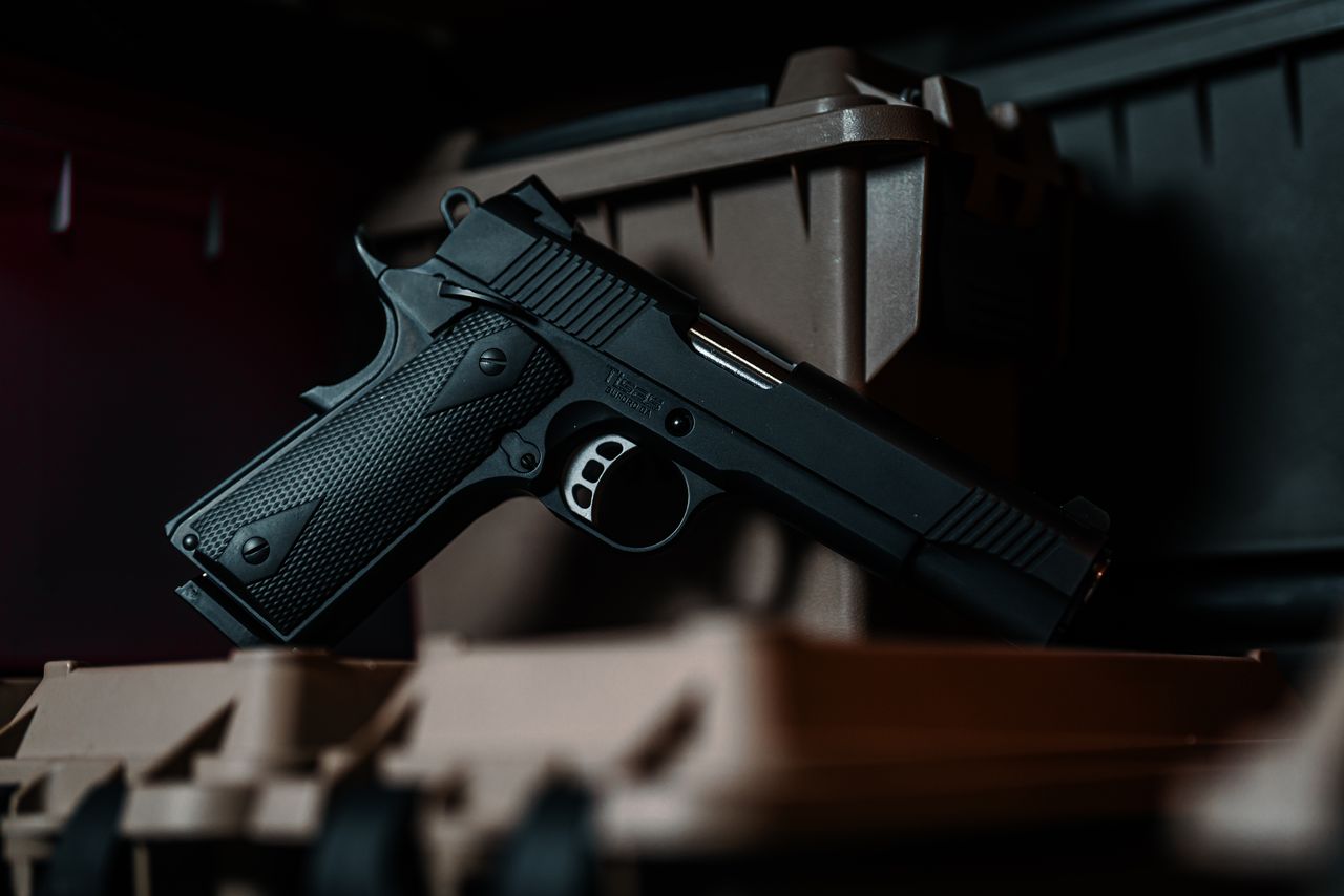 A black Tisas 1911 Duty resting on its case