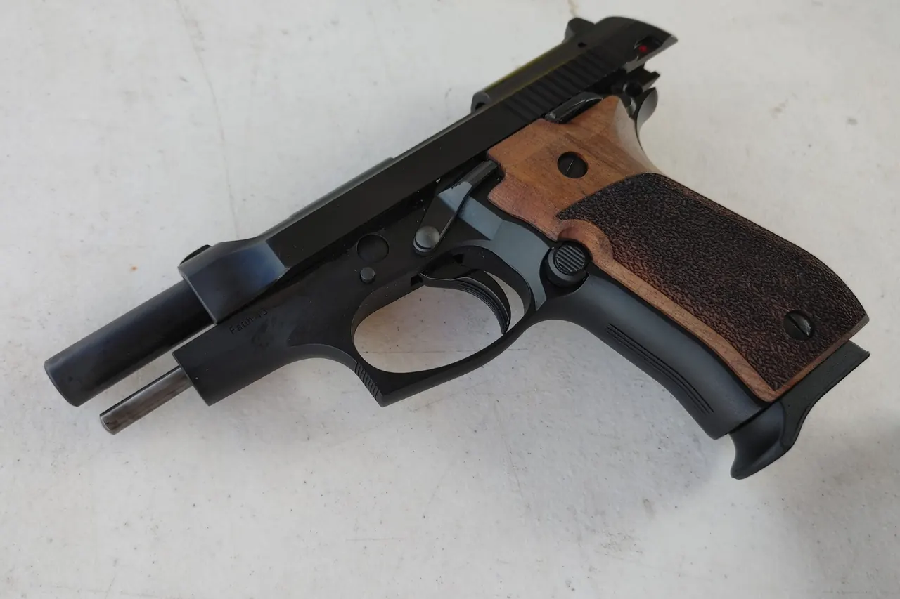 A Tisas Fatih 13 part stripped on a workbench, slide and barrel separated from the frame