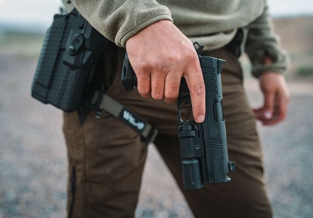 Tisas DS Comp, with a light, drawn from a belt holster