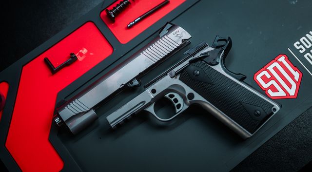 Tisas Carry, stainless rail Carry field stripped on the bench mat
