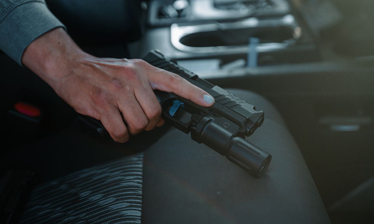 A Tisas PX-9 Duty with a weapon light, carried in a vehicle