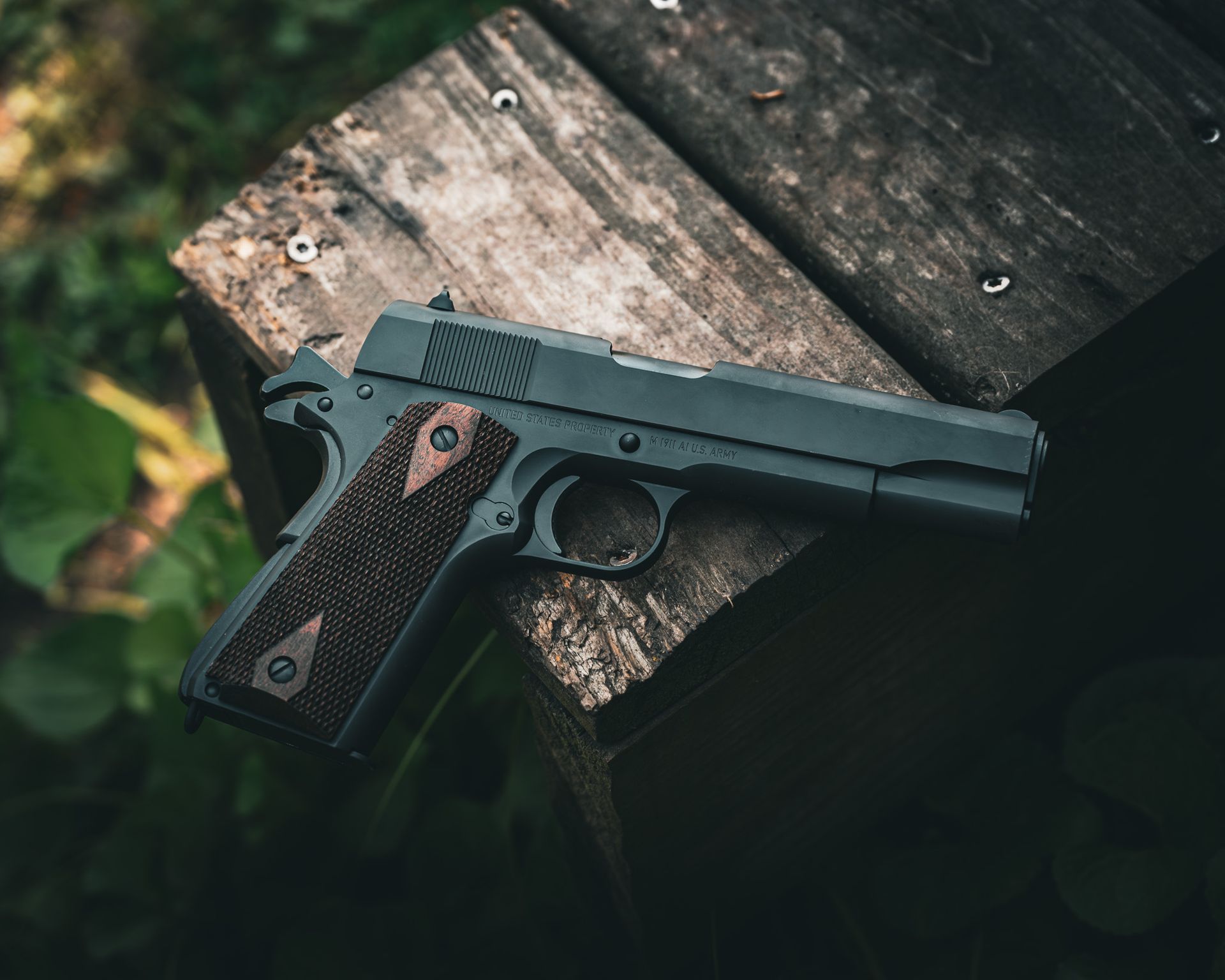 A Tisas 1911A1 resting on a weathered wooden surface