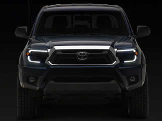 Raxiom 12-15 Toyota Tacoma Axial Series Switchback Projector Headlights- Black Housing- Clear Lens