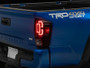 Raxiom 16-23 Toyota Tacoma XW Series Sequential LED Tail Lights- Black Housing- Red Lens
