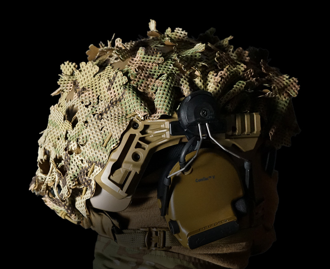 Side view of Carcajou Tactical high cut helmet with Multicam scrim cover and ComTac headset, available at Hudson Supplies Corp USA