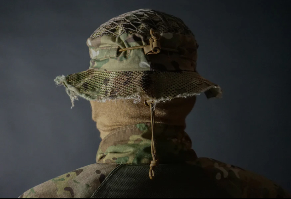 Close-up rear view of Carcajou sniper boonie hat in Multicam with mesh camouflage netting and ITW cord lock adjustment, available at Hudson Supplies Corp USA.
