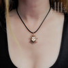 rose gold scarab beetle necklace with black choker
