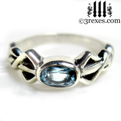 silver friendship ring with blue topaz stone