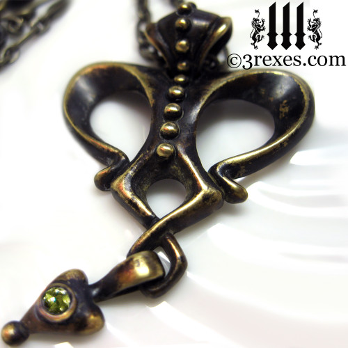 queen of hearts brass necklace with green peridot gothic stone