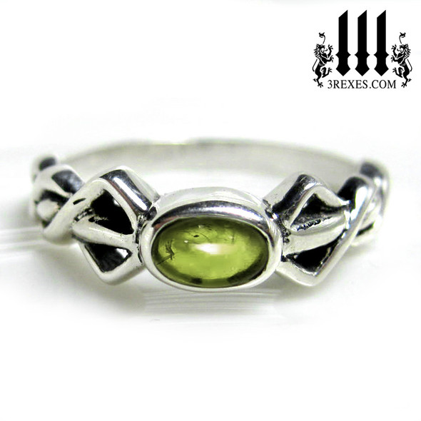 silver friendship ring with green peridot stone celtic knot