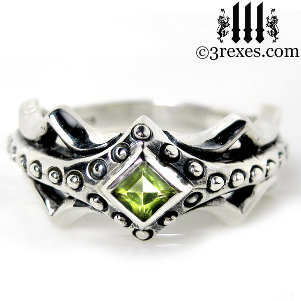 silver medieval engagement ring with green peridot stone