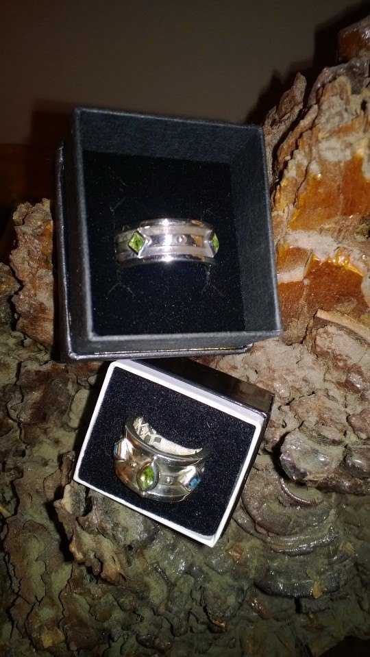 silver wedding ring set with green stones