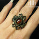 empress vampire brass ring with amber cabochon on middle finger