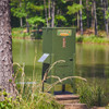 Texas Hunter fish feeder on pond shoreline