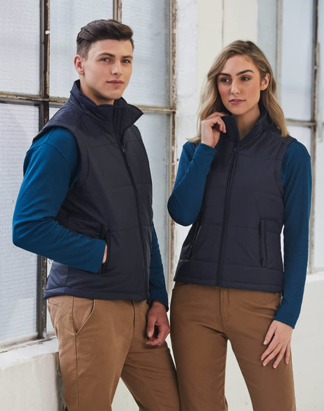 A navy padded vest featuring a zip front and side pockets, modeled by a man and woman in casual attire.