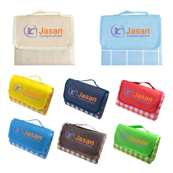 A collection of large picnic blankets in various colours including yellow, blue, red, and brown, each with a logo.