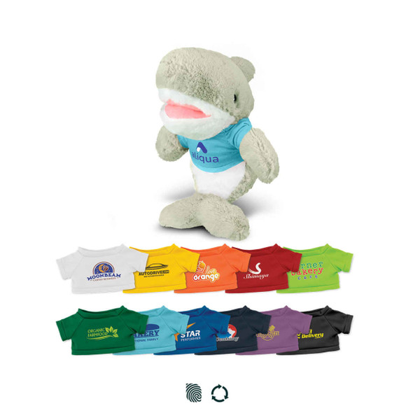 A plush shark toy in grey and white, wearing a blue top, surrounded by various mini t-shirts in different colours.