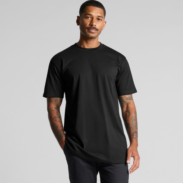 A black Classic Plus Tee with short sleeves, featuring a logo, worn by a man with tattoos.