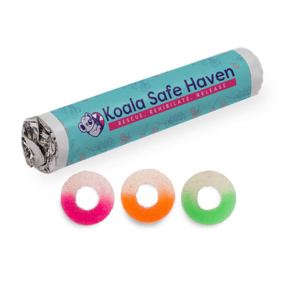 Assorted fruit-flavoured gummy rings in pink, orange, and green, packaged in a cylindrical wrapper with a logo.