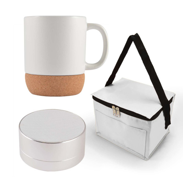 A coffee mug with a cork base, a small speaker, and a white carrying case with a black strap.
