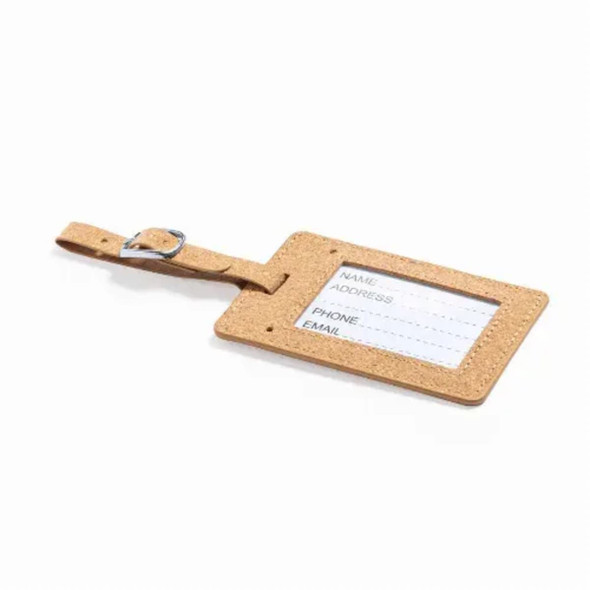 A luggage tag in a light brown colour with a transparent sleeve for information and a buckle strap.