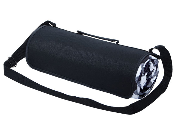 A large picnic rug rolled up in a black carry bag with a shoulder strap and a patterned inner design.