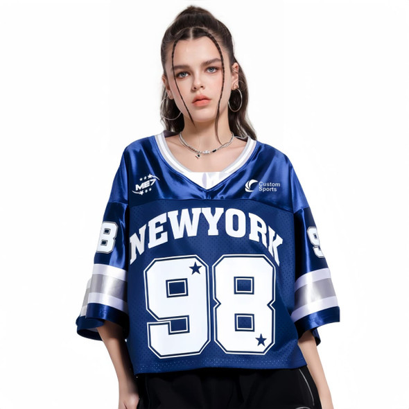 A blue unisex crop jersey featuring 'NEW YORK' and the number '98', with a shiny finish and a logo. A blue unisex crop jersey featuring 'NEW YORK' and the number '98', with a shiny finish and a logo.