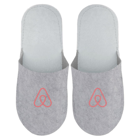 Grey felt slippers featuring a logo on the front, designed for comfort and cosy wear.