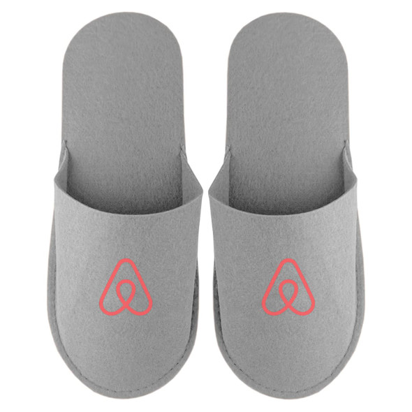 A pair of grey felt slippers featuring a logo, designed for comfort and casual wear.