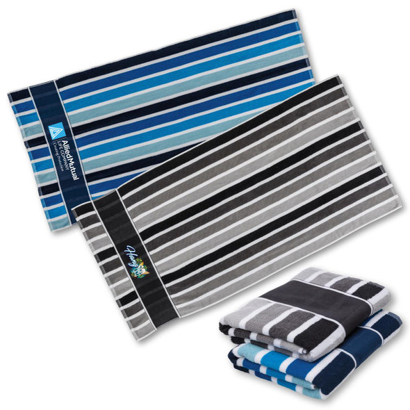 A set of striped towels in shades of blue, grey, and black, featuring a logo on one towel.