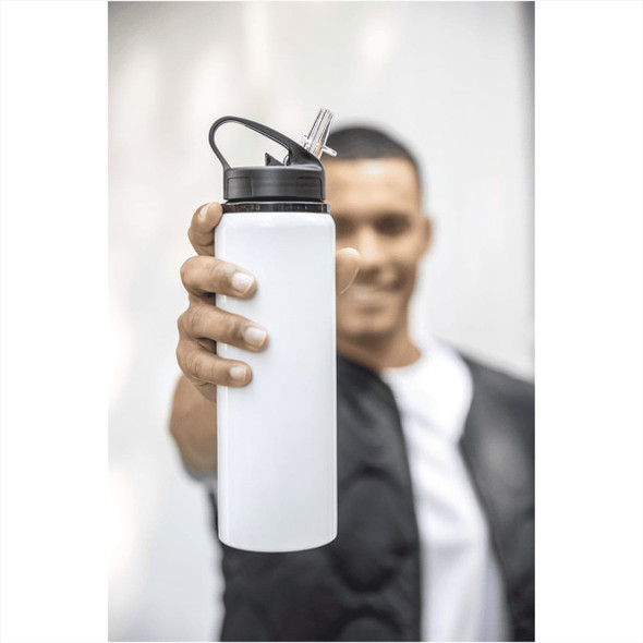 A drink bottle in white with a black lid and a built-in straw, held by a person. It has a logo on it.